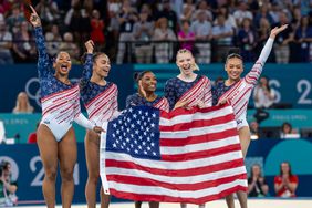 Jordan Chiles, Hezly Rivera, Simone Biles, Jade Carey, Suni Lee Holding Up American Flag and Cheering After Winning Gold During Women's Artistic Gymnastics Team All-Around 2024 Paris Olympics