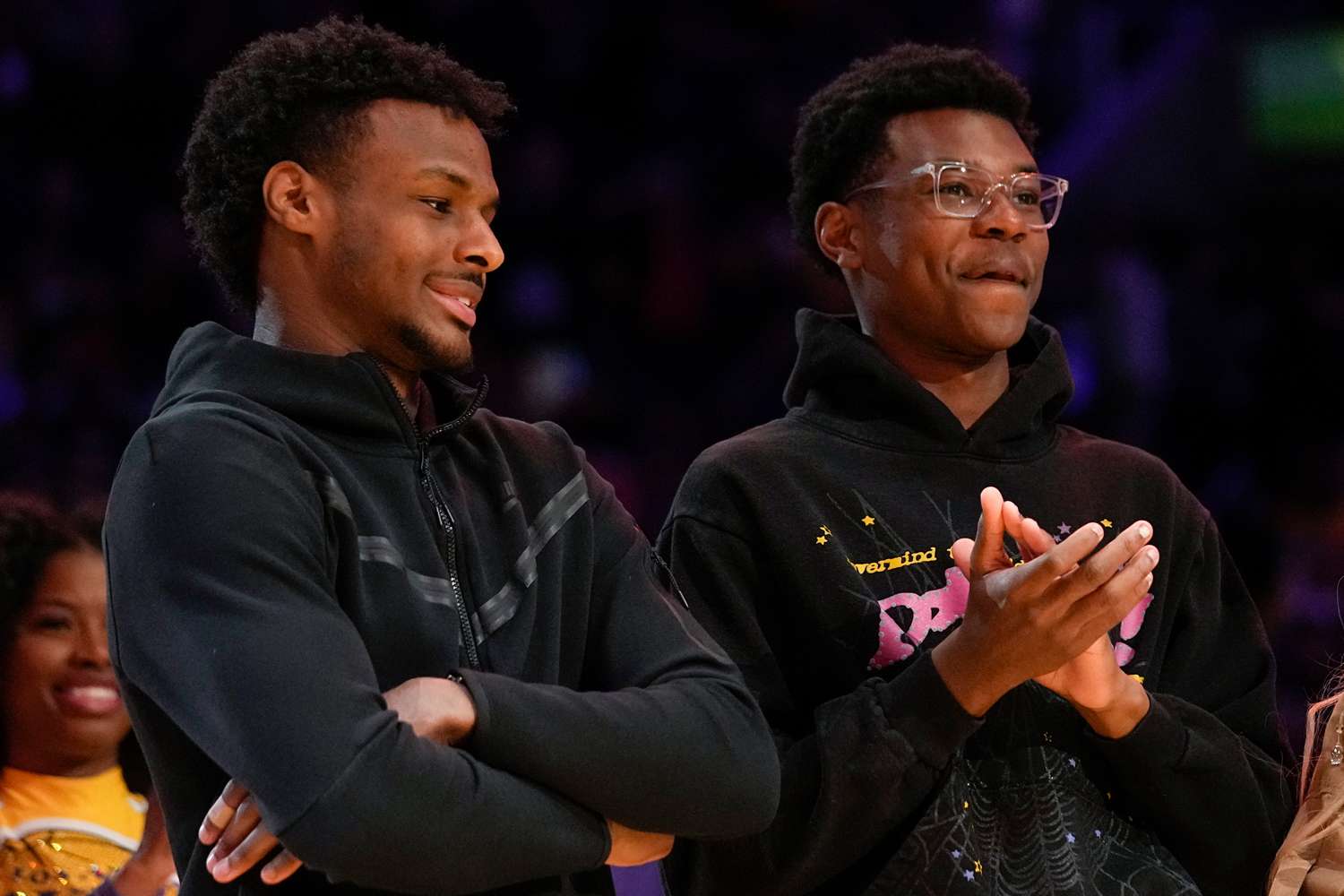 Bronny James, Bryce James, and Savannah James applaud during a ceremony honoring Los Angeles Lakers forward LeBron James as the NBA's all-time leading scorer before an NBA game against the Milwaukee Bucks on Thursday, Feb. 9, 2023
