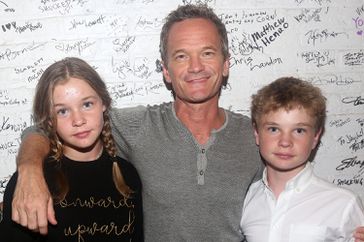 Harper Grace Burtka-Harris, Neil Patrick Harris, Gideon Burtka-Harris pose backstage at the hit musical "Shucked" on Broadway at The Nederlander Theatre on September 9, 2023 