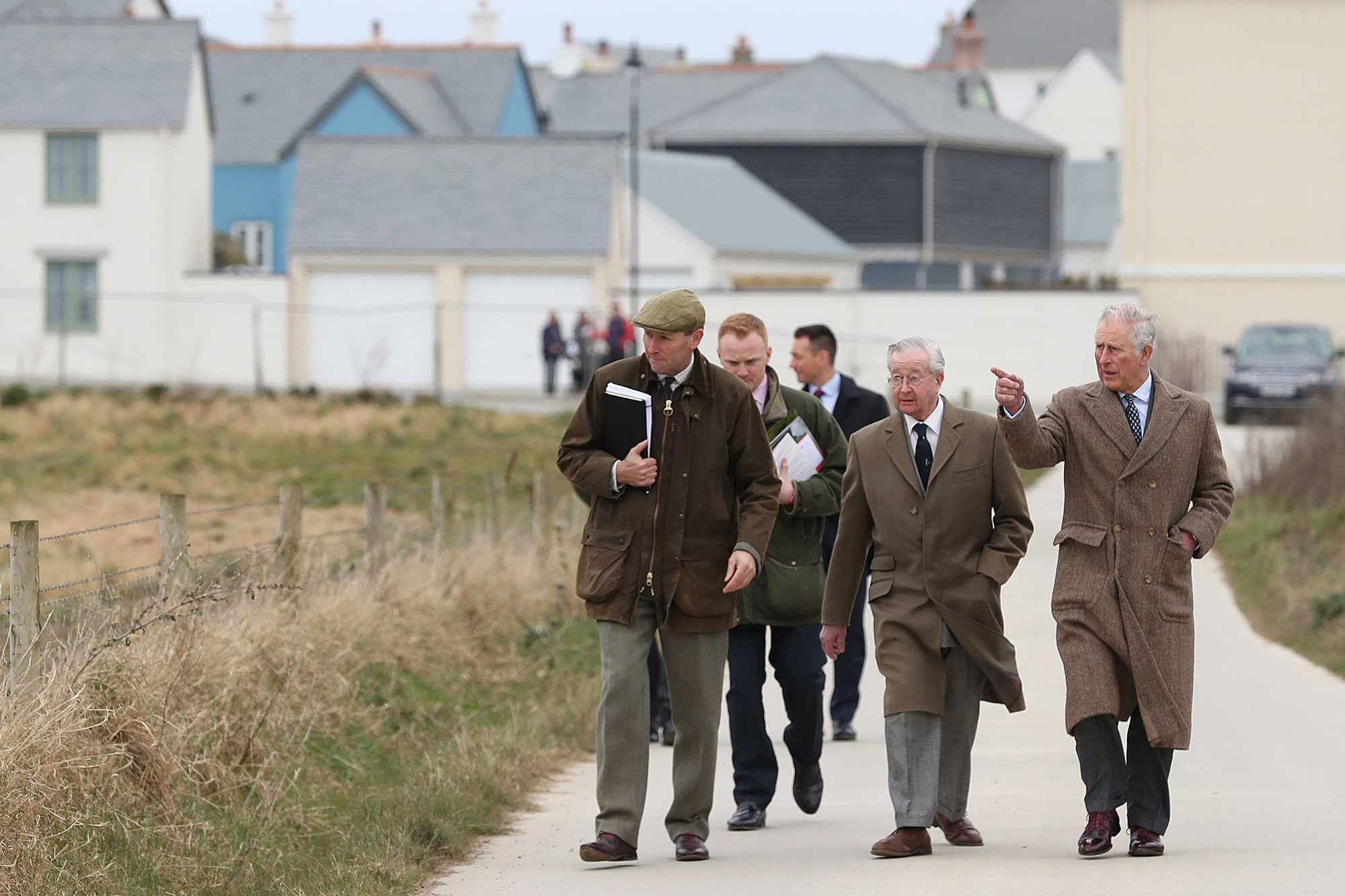 Prince Charles, Prince of Wales walks with Alastair Martin, Duchy of Cornwall Secretary & Keeper of the Records (L) and Michael Galsworthy (C) during a visit to Nansledan in Cornwall where he met local residents and unveiled a plaque for the development's new school on March 22, 2018 in Nansledan, England.