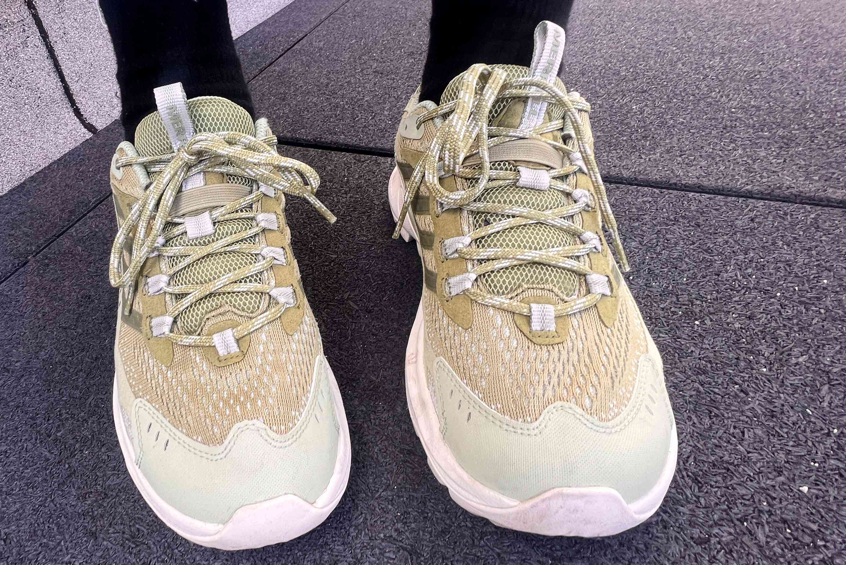 A person wears the Merrell Women's Moab Speed 2 Hiking Shoes outside