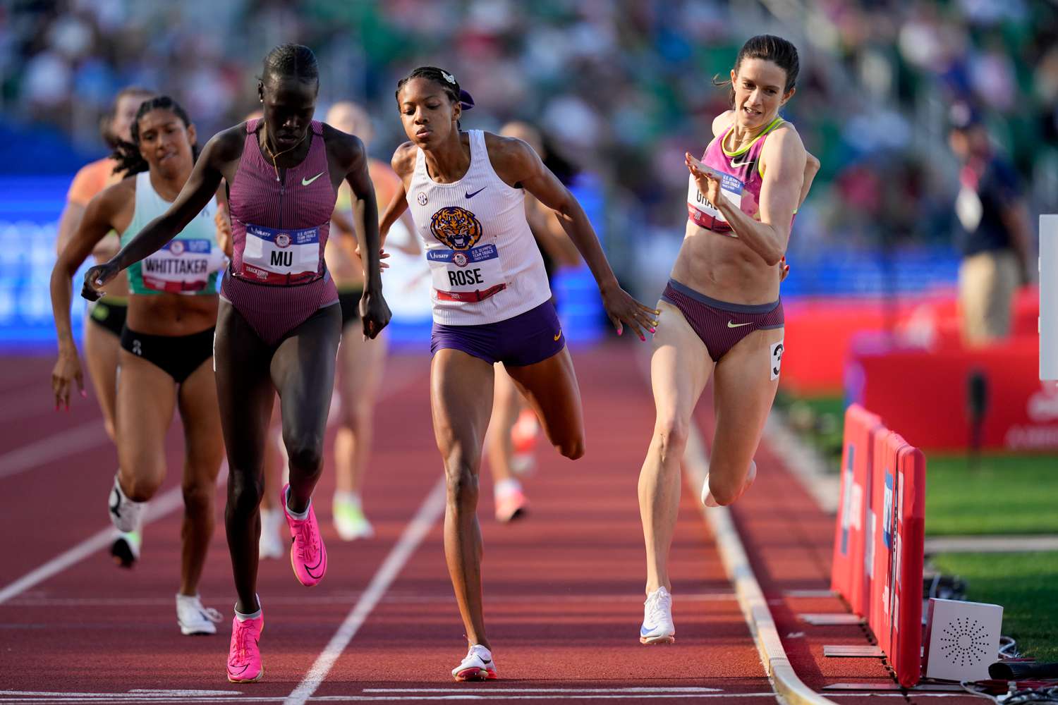 Athing Mu wins a heat in the women's 800-meter semi-final as Kate Grace and Michaela Rose collide during the U.S. Track and Field Olympic Team Trials Sunday, June 23, 2024, in Eugene, Ore