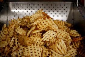 A fresh batch of waffle fries sit before being served at a Chick-fil-A Inc. restaurant in Bowling Green, Kentucky, U.S., on Tuesday, Mar. 25, 2014. 