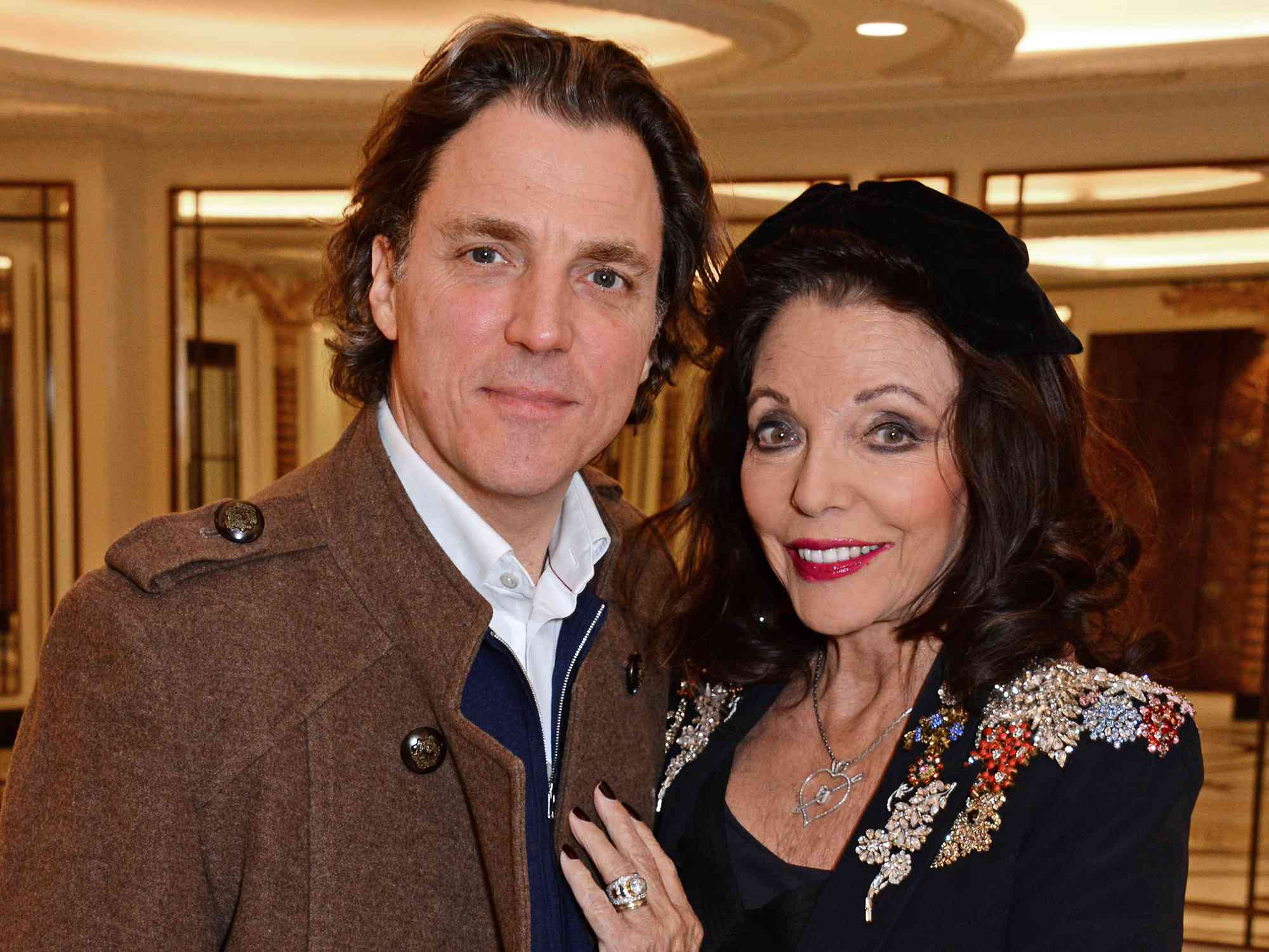 Alexander Newley and Dame Joan Collins attend a festive afternoon tea hosted by patron Dame Joan Collins for Shooting Star Chase supported children and their families at The Dorchester on December 19, 2018 in London, England