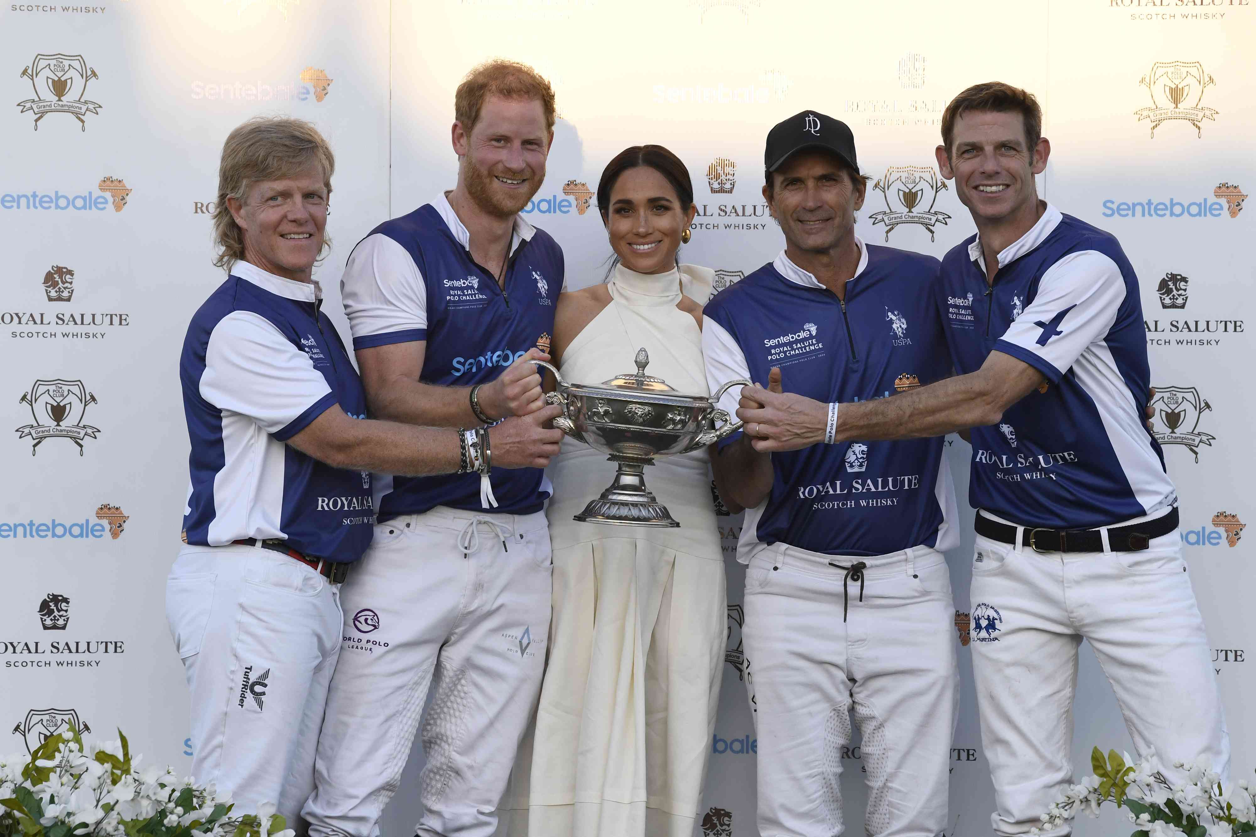 Dana Barnes, Prince Harry, Duke of Sussex, Meghan, Duchess of Sussex, Adolfo Cambiaso and Malcolm Borwick during the Royal Salute Polo Challenge benefitting Sentebale at Grand Champions Polo Club on April 12, 2024 in Wellington, Florida. The annual Polo Cup has been running since 2010, and to date has raised over ÃÂ£11.4 million to support Sentebale's work with children and young people affected by poverty, inequality and HIV/AIDS in southern Africa.