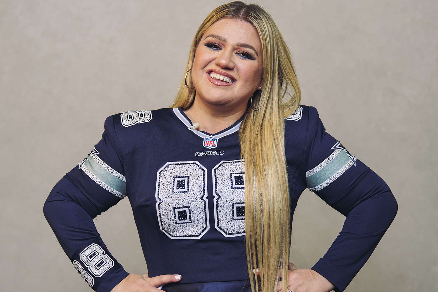 Kelly Clarkson poses for a photo while wearing a Dallas Cowboy dress during NFL Honors at the Symphony Hall