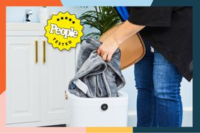 A person puts a blanket into the TMWings Bucket Towel Warmer.