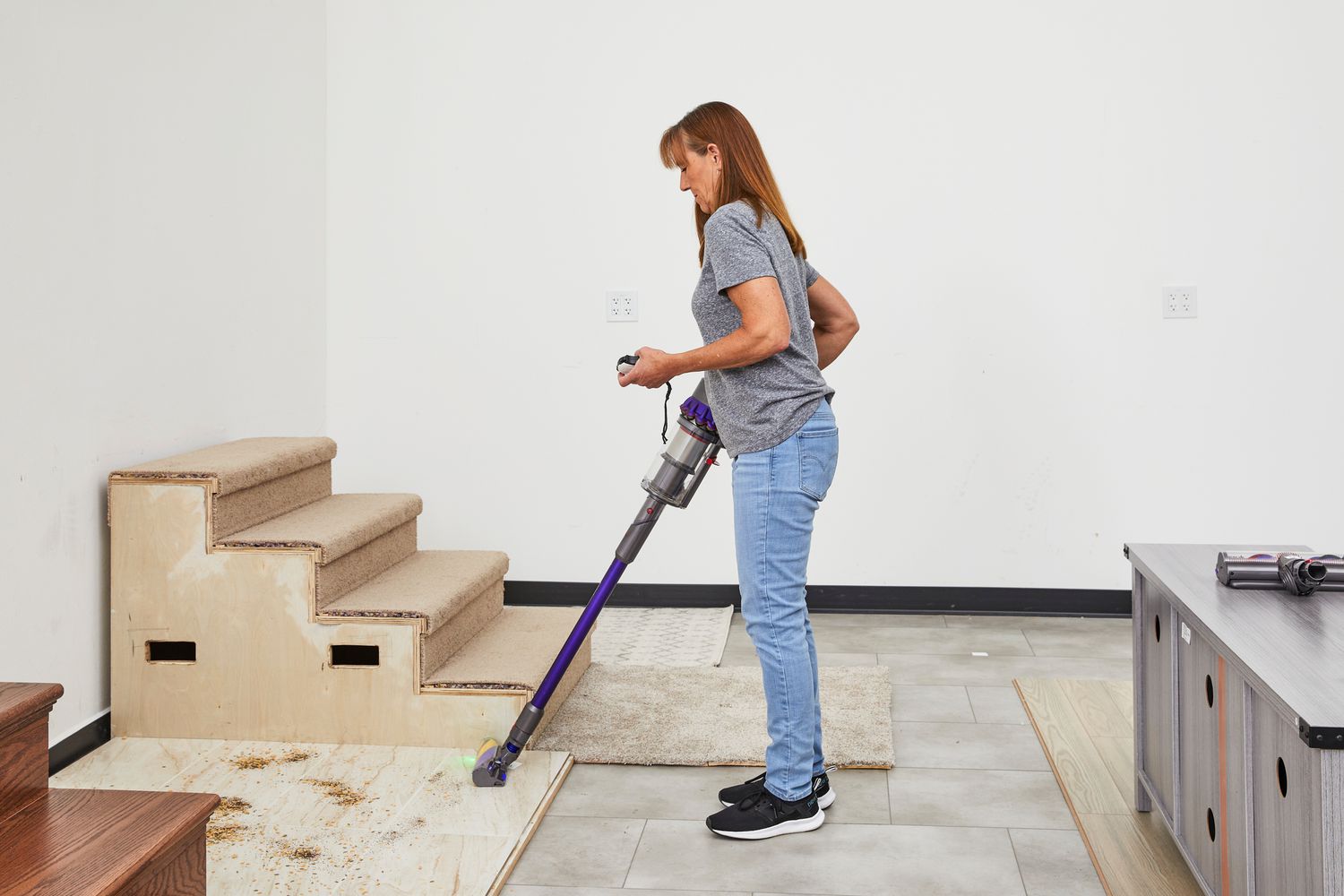 A person using the Dyson Gen5detect to vacuum a wood floor