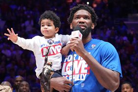  Joel Embiid, and his son Arthur, as he receives The Michael Jordan KIA MVP Trophy n May 5, 2023. 