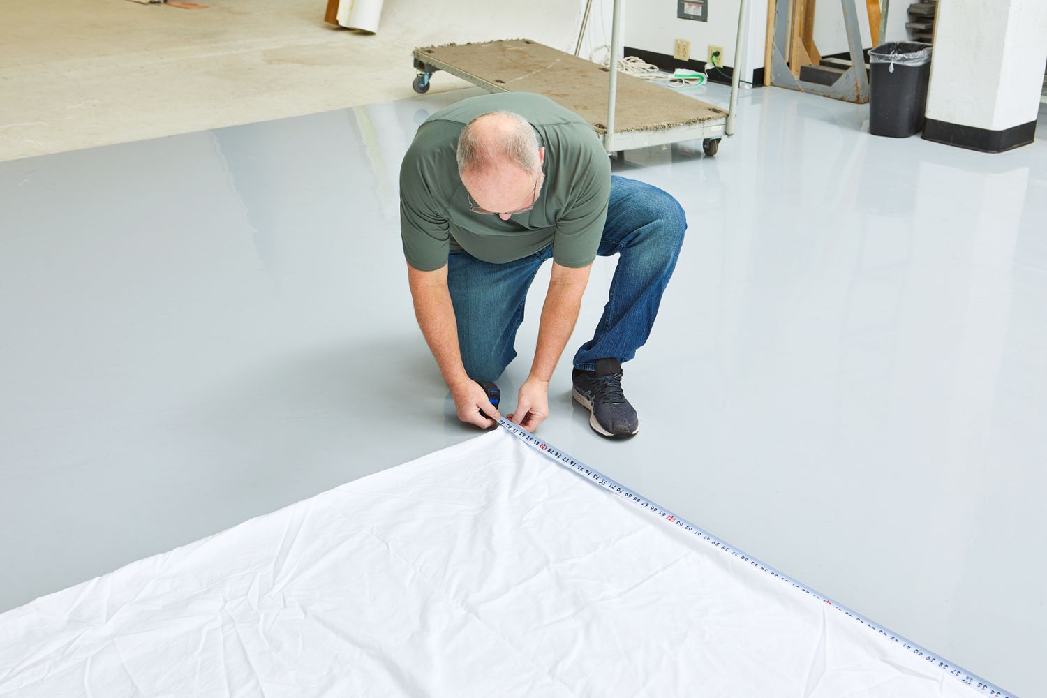 Person measuring a Brooklinen Luxury Sateen Duvet Cover on the floor