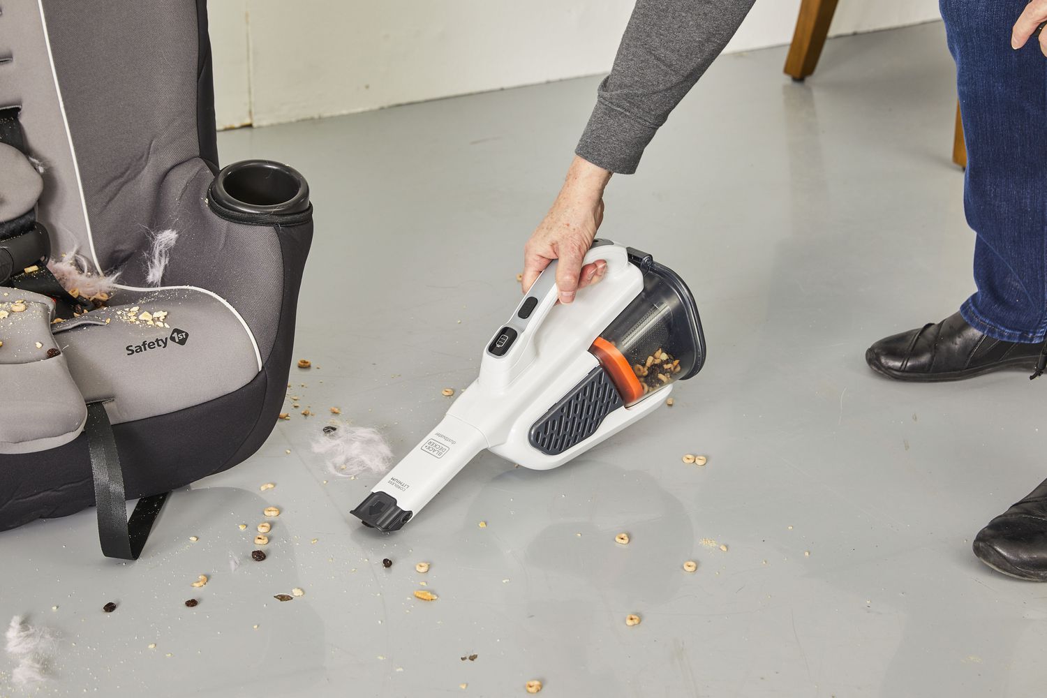 Person cleaning dirt on floor using Black+Decker Gen11 AdvancedClean+ Dustbuster