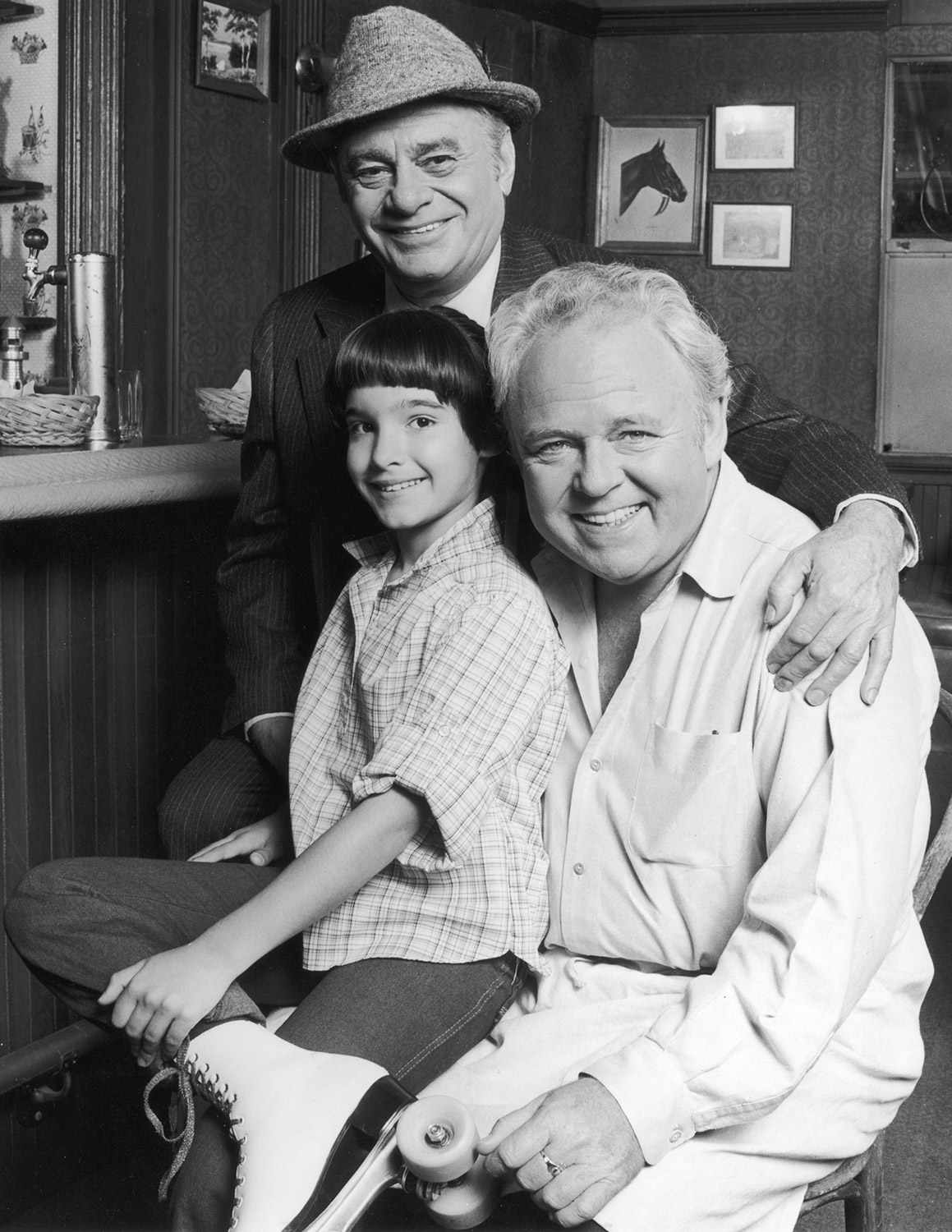 1979: Promotional portrait of actors Carroll O'Connor (1924 - 2001; right), Martin Balsam (1919 - 1996), and Danielle Brisebois in costume and on the set, for the premiere season of the television series 'Archie Bunker's Place'. Briesbois is sitting on O'Connor's lap and is wearing rollerskates. (Photo by CBS Photo Archive/Getty Images)