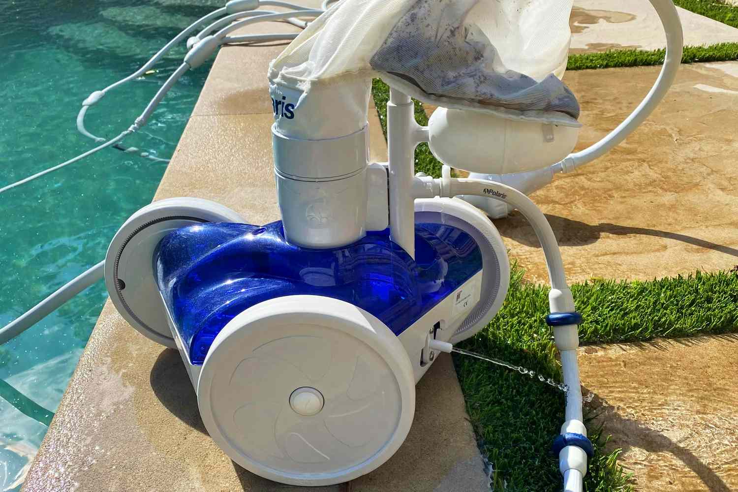 Polaris Vac-Sweep 280 Pressure Inground Pool Cleaner displayed on the edge of a pool