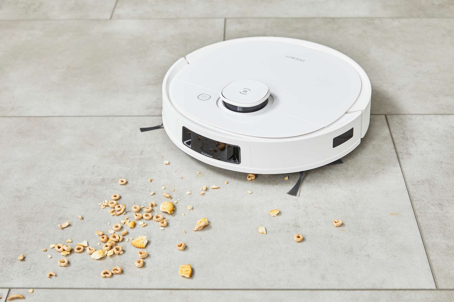 The Ecovacs Deebot T9+ Robot Vacuum and Mop Combo cleans Cheerios and crackers from a tile floor