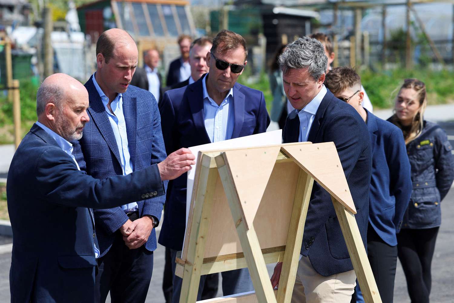 Britain's Prince William, Prince of Wales and Duke of Cornwall (2L) and Alastair Martin Secretary of Duchy of Cornwall, are shown plans during a visit to a Duchy of Cornwall housing project, in Newquay, South West England, on May 9, 2024