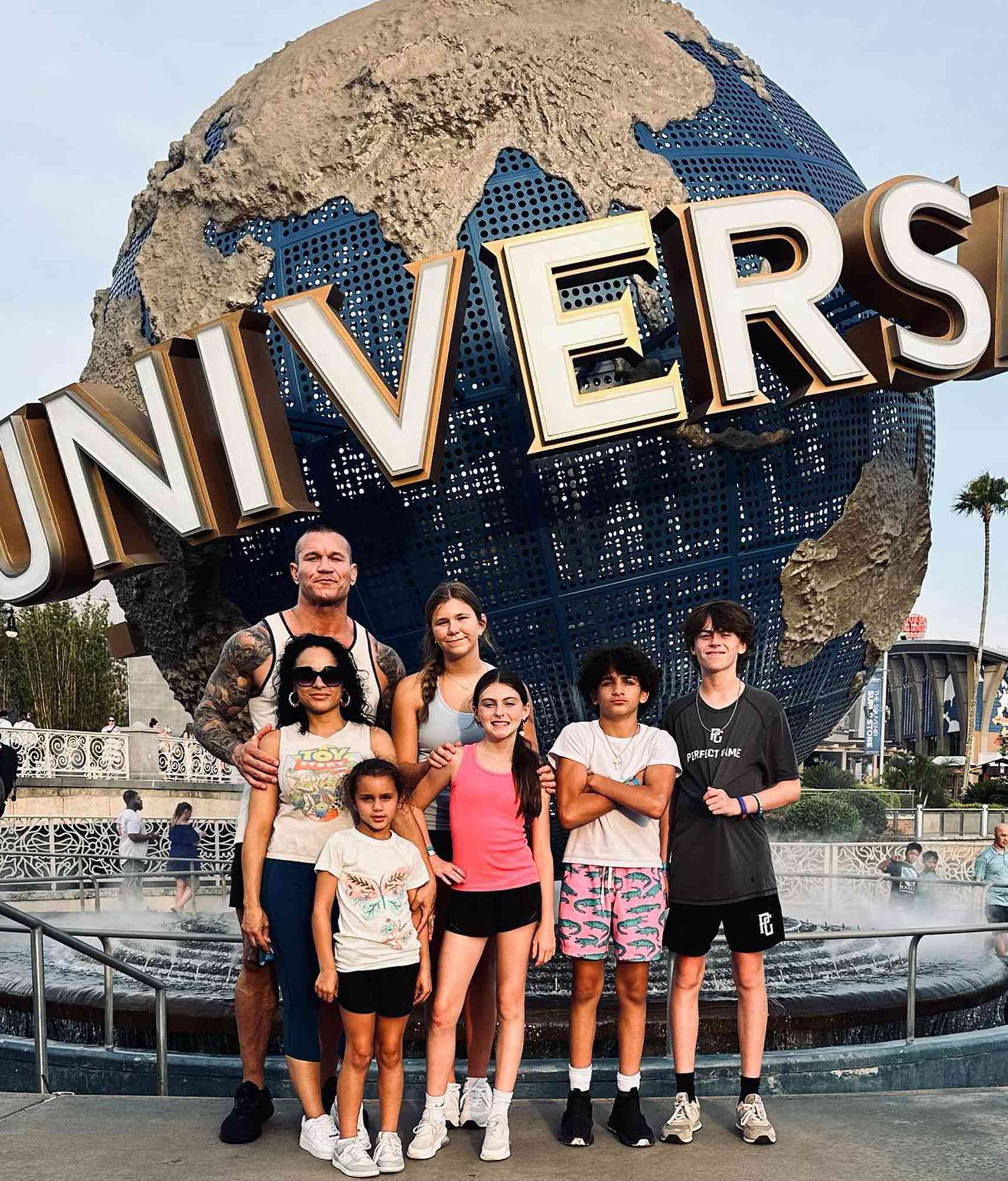 Randy Orton and Kim Marie Kessler posing with their kids at Universal Studios