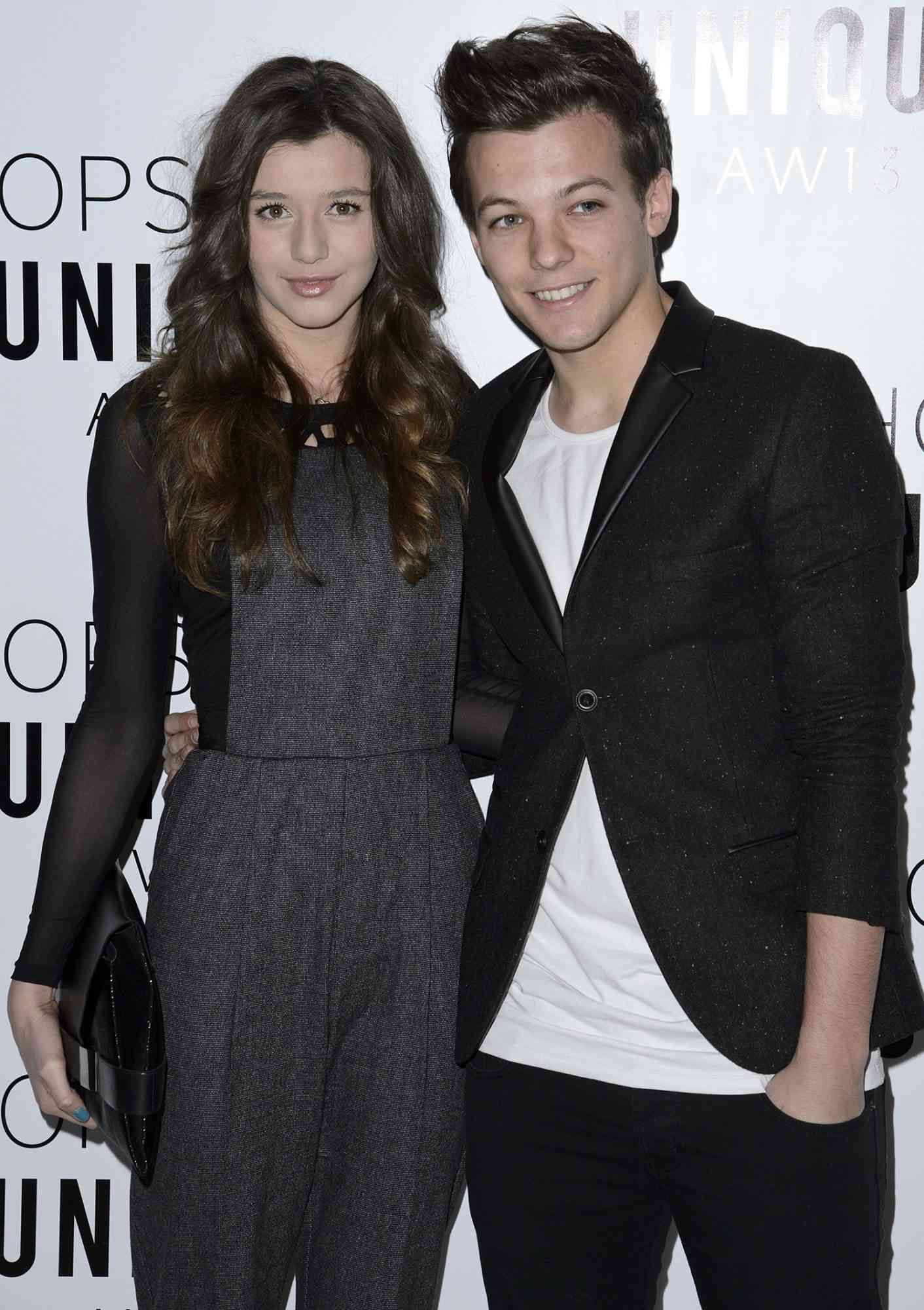 Eleanor Calder and Louis Tomlinson of One Direction attends the Topshop Unique Autumn/ Winter 2013 catwalk show
