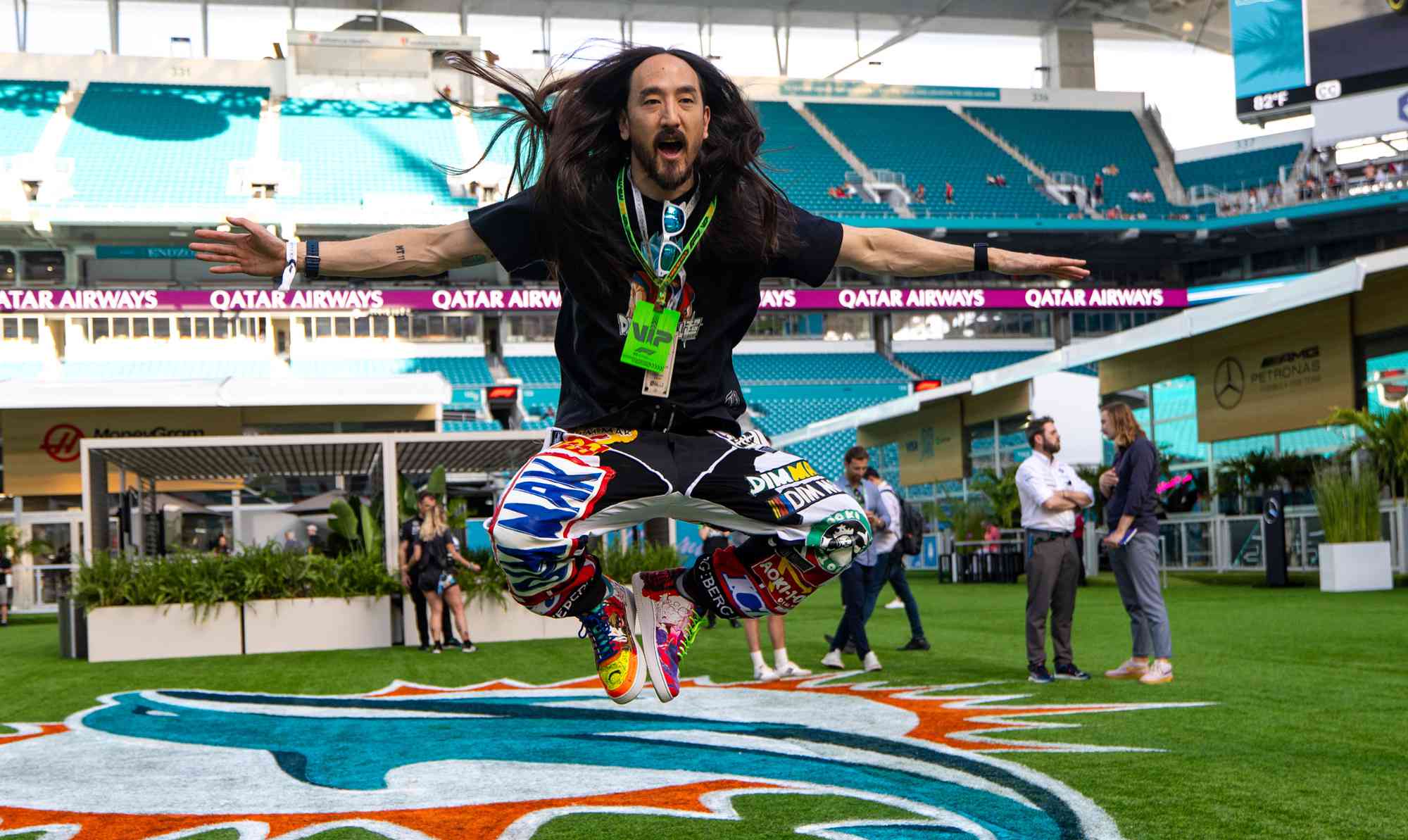 Steve Aoki jumps in the paddock during practice ahead of the F1 Grand Prix of Miami