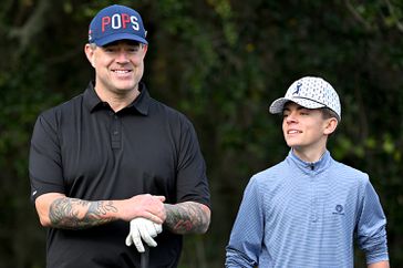 Carson Daly and his son stand together on the first hole prior to PNC Championship at Ritz-Carlton Golf Club on December 15, 2023 in Orlando, Florida. 