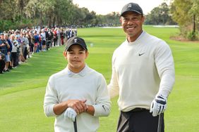 Tiger Woods of The United States poses with his son Charlie Woods on the first tee during the Friday pro-am as a preview for the 2022 PNC Championship