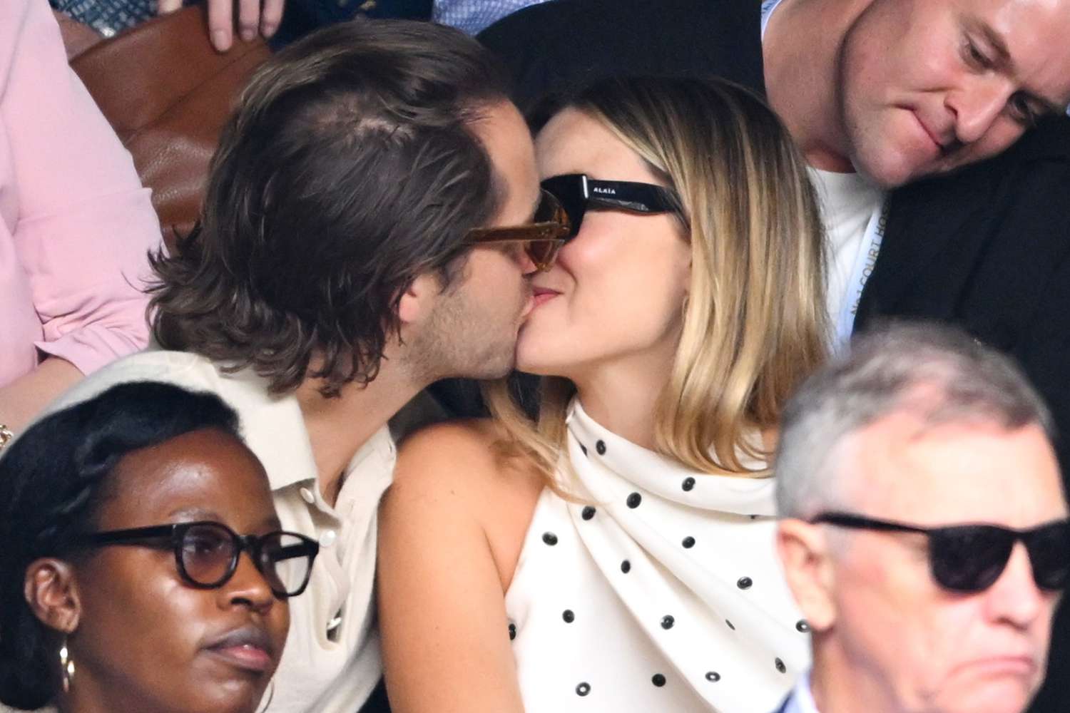 Tom Ackerley and Margot Robbie kiss court-side of Centre Court on day twelve of the Wimbledon Tennis Championships 