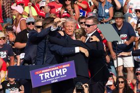 Republican candidate Donald Trump is seen with what appears to be blood on his face surrounded by secret service agents as he is taken off the stage at a campaign event at Butler Farm Show Inc. in Butler, Pennsylvania, July 13, 2024. 