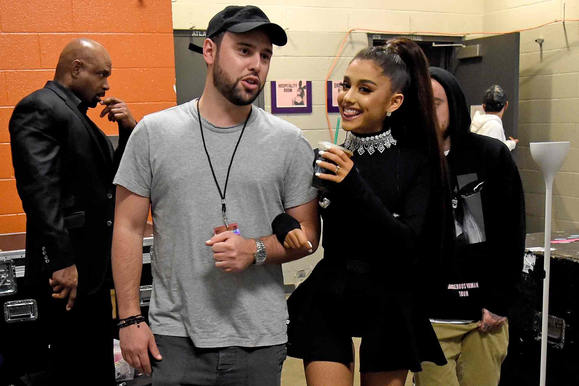 Scooter Braun and Ariana Grande walk backstage during the "Dangerous Woman" Tour 