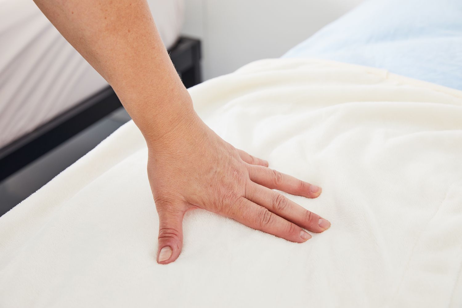 Hand pressing on the Degrees of Comfort Micro-Plush Heated Blanket