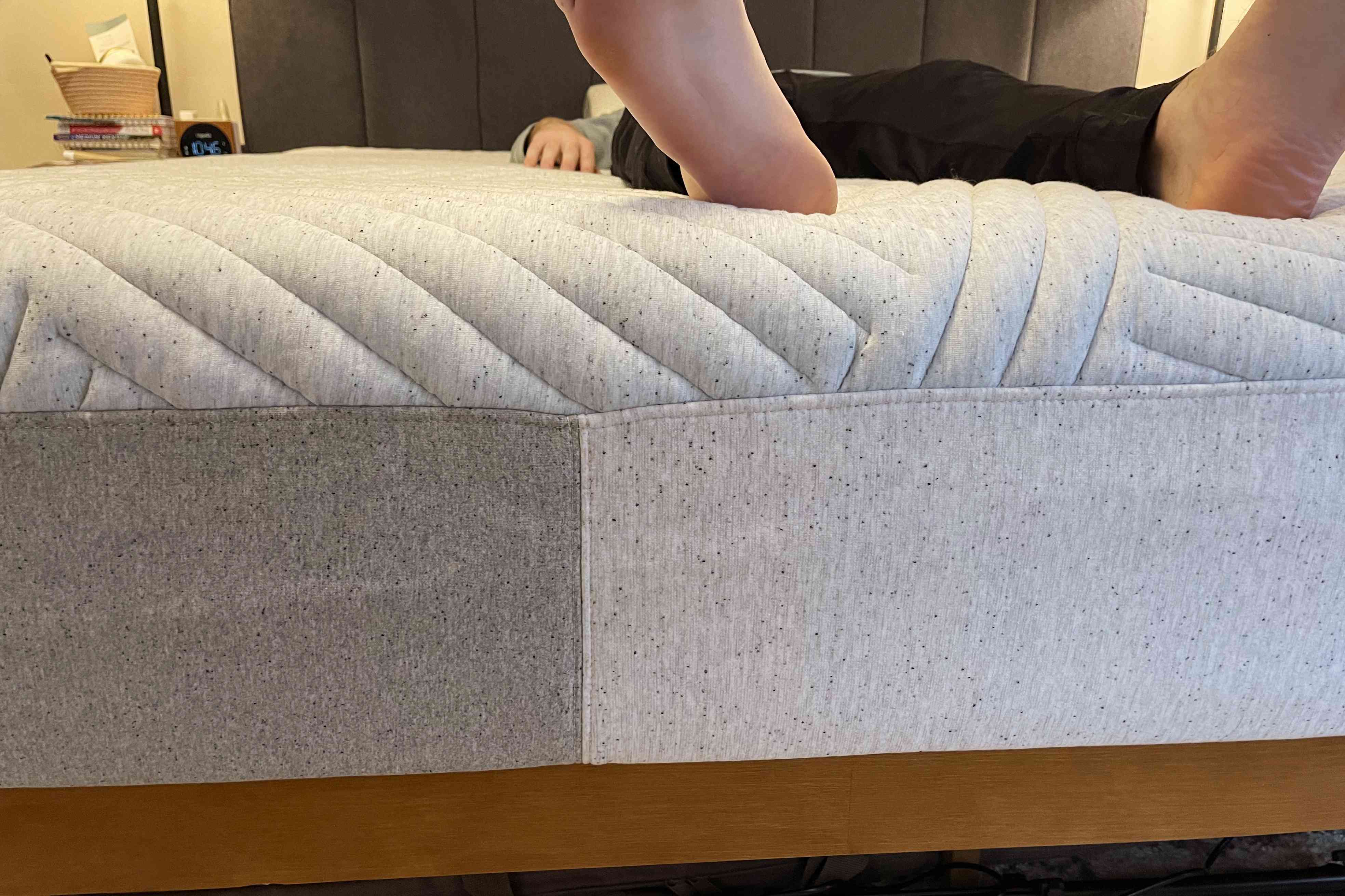 A person laying down on the Casper Wave Hybrid Mattress