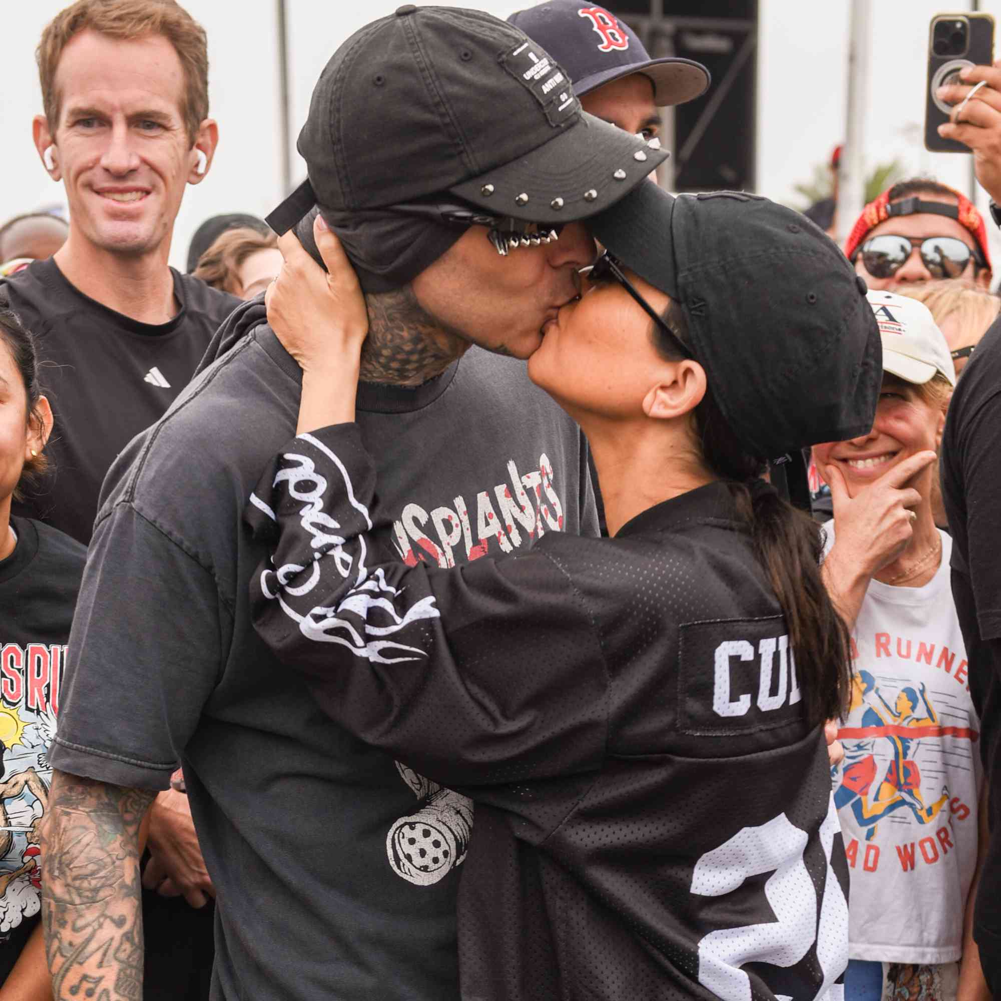 Travis Barker and Kourtney Kardashian (C) attend Travis Barker's Run Travis Run: A Run & Wellness Experience at The Kia Forum on July 06, 2024 in Inglewood, California. 