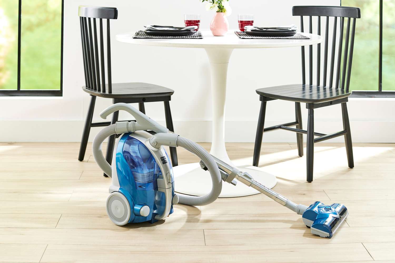 The Kenmore Compact Bagless Canister Vacuum 10701 displayed next to a table and chairs