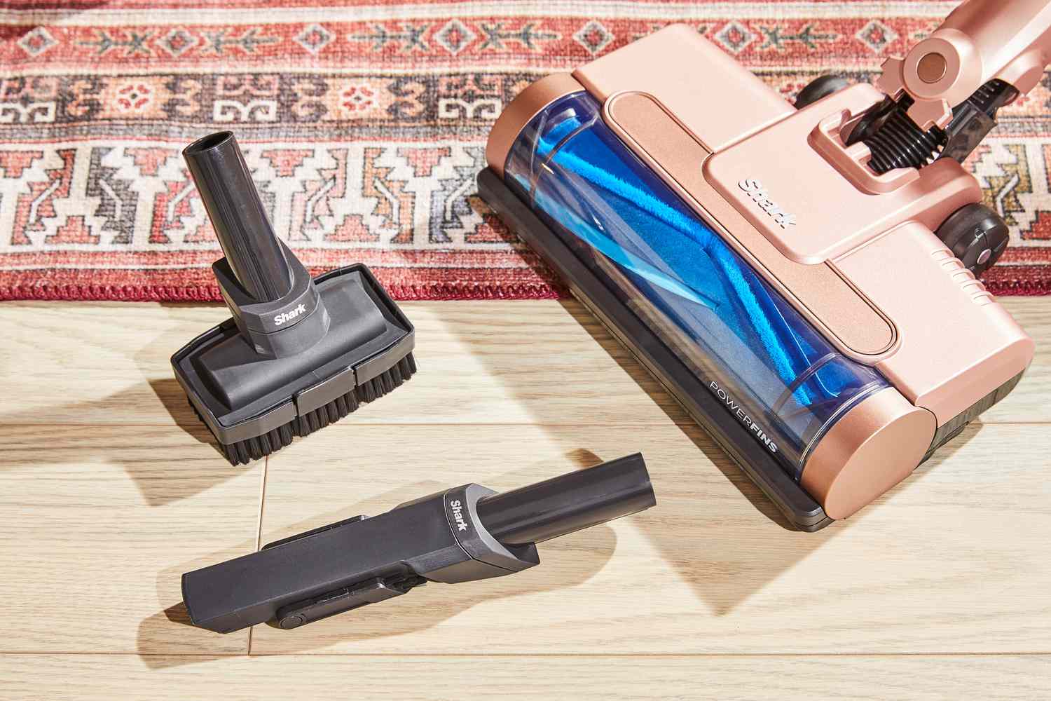 The Shark Wandvac on a floor next to accessories