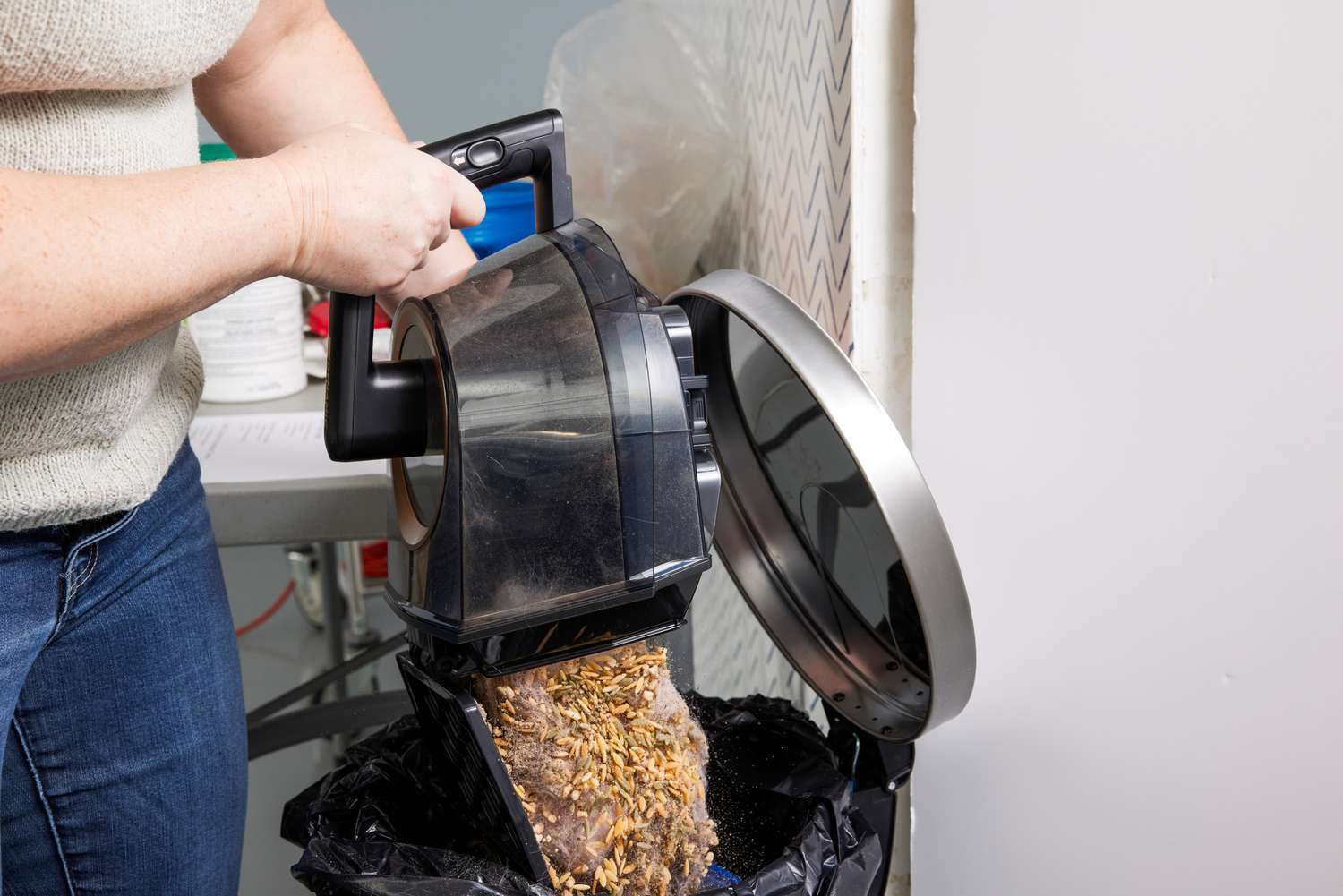 The Shark CZ2001 Vertex Canister Vacuum is emptied into the trash