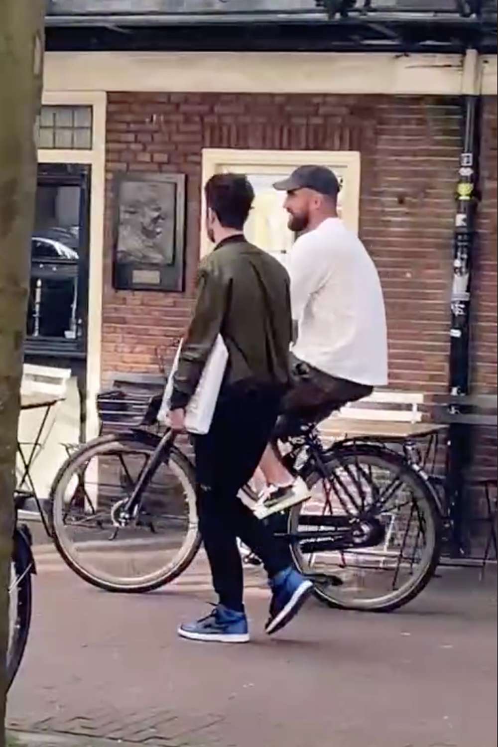 Travis Kelce Riding a bike in Amsteram