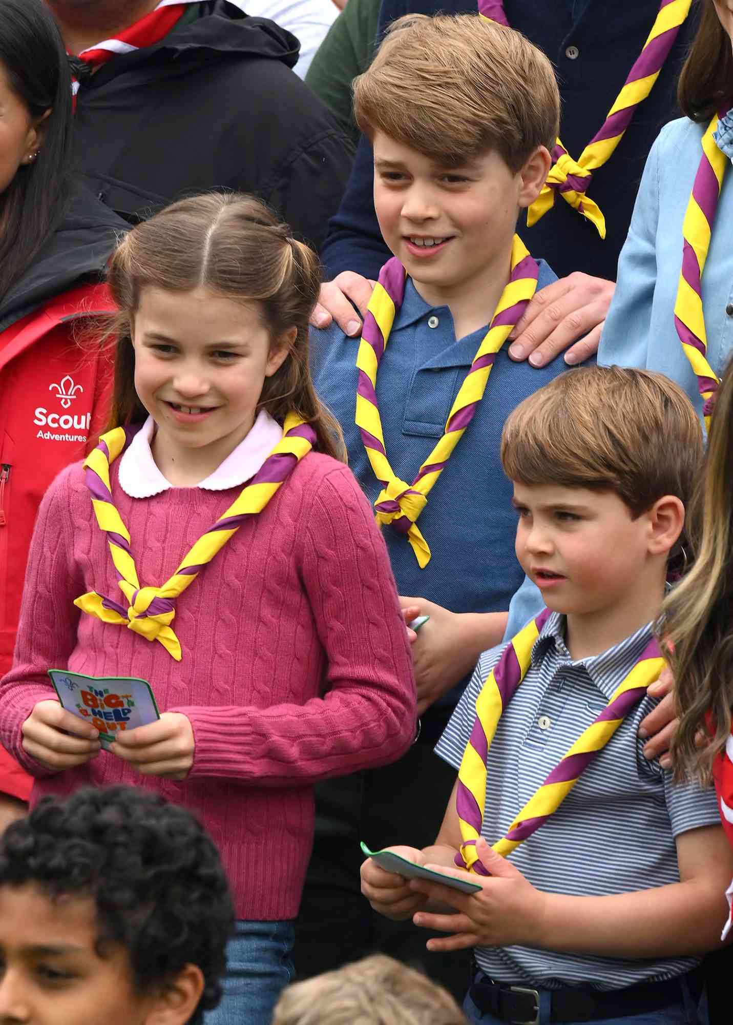 Prince George of Wales, Prince Louis of Wales (R) and Princess Charlotte of Wales pose for a group picture with volunteers who are taking part in the Big Help Out, during a visit to the 3rd Upton Scouts Hut in Slough