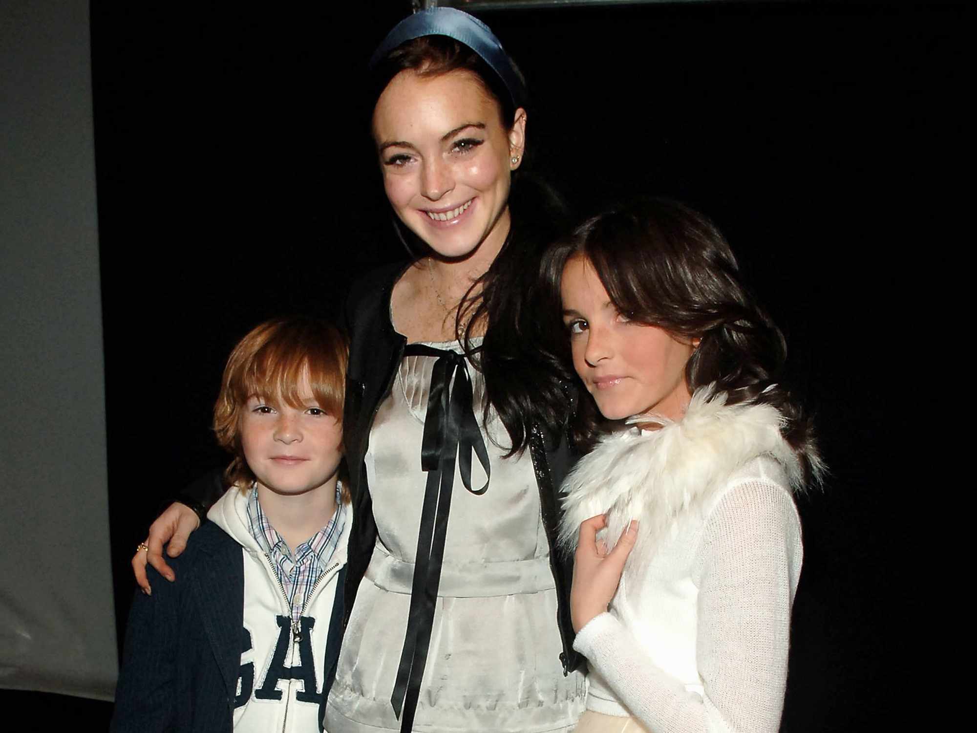 Lindsay Lohan and her brother Dakota and sister Aliana backstage at the Child Magazine Fall 2006 fashion show on February 6, 2006 in New York City.