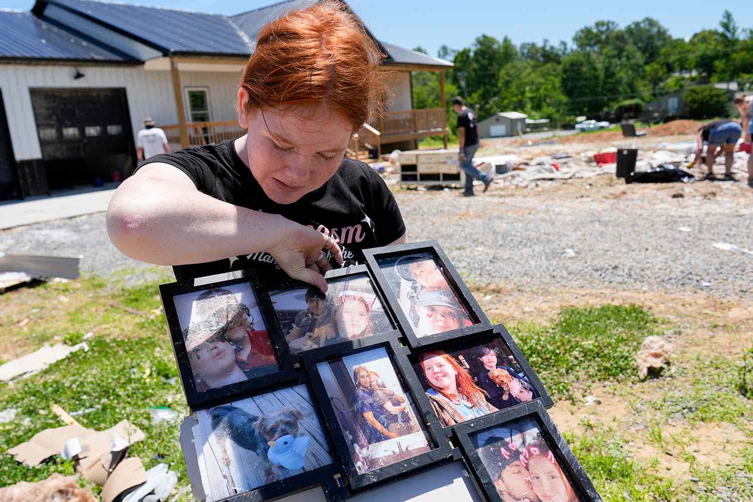 Haley Loukota, looks over family photographs found among storm debris from her demolished home along Barnsley Loop, Tuesday, May 28, 2024, in Madisonville, Ky. A series of powerful storms hit the central and southern U.S. over the Memorial Day holiday weekend. 