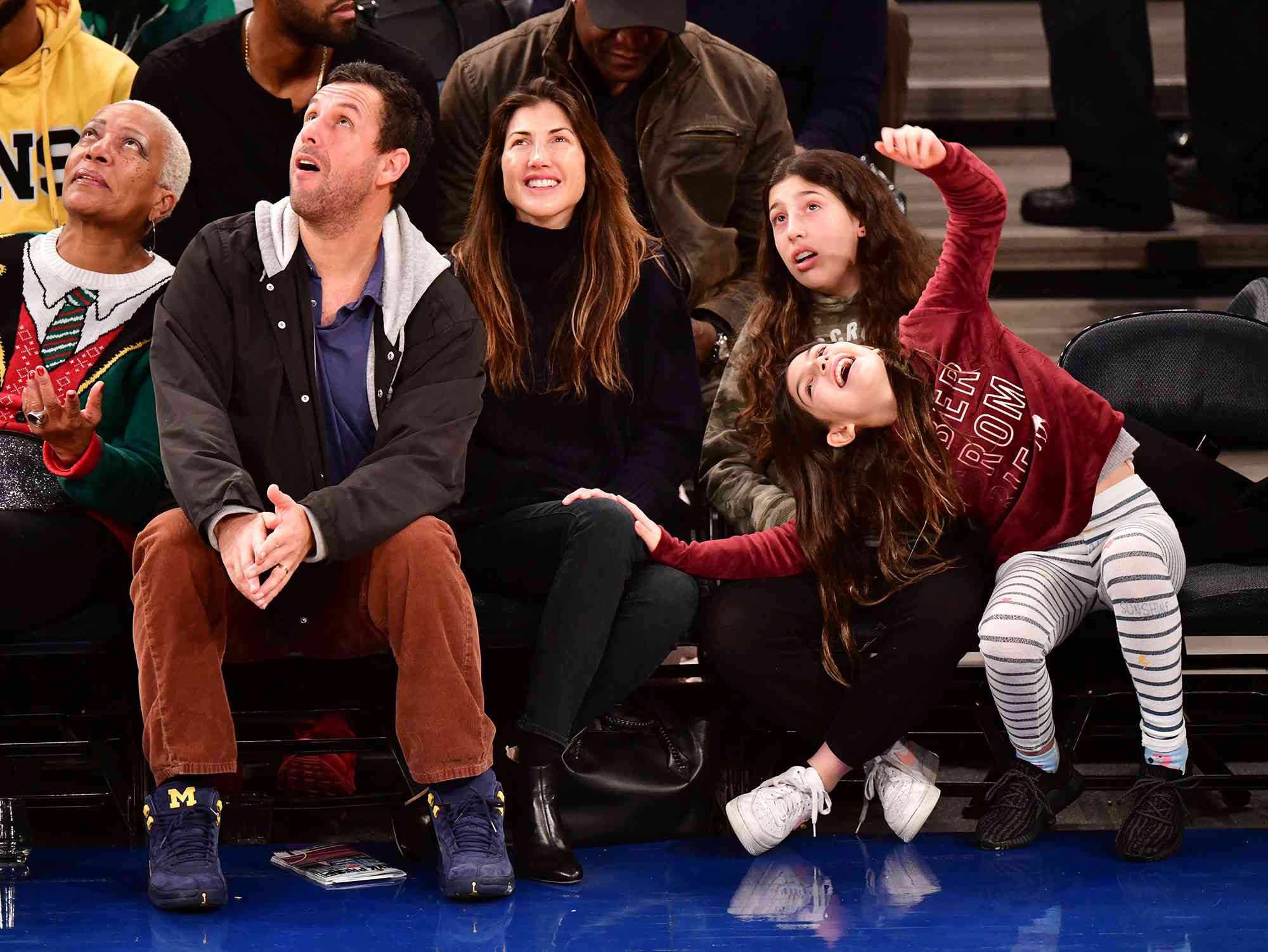 Adam Sandler, Jackie Sandler, Sadie Sandler and Sunny Sandler attend Milwaukee Bucks v New York Knicks game at Madison Square Garden on December 25, 2018 in New York City