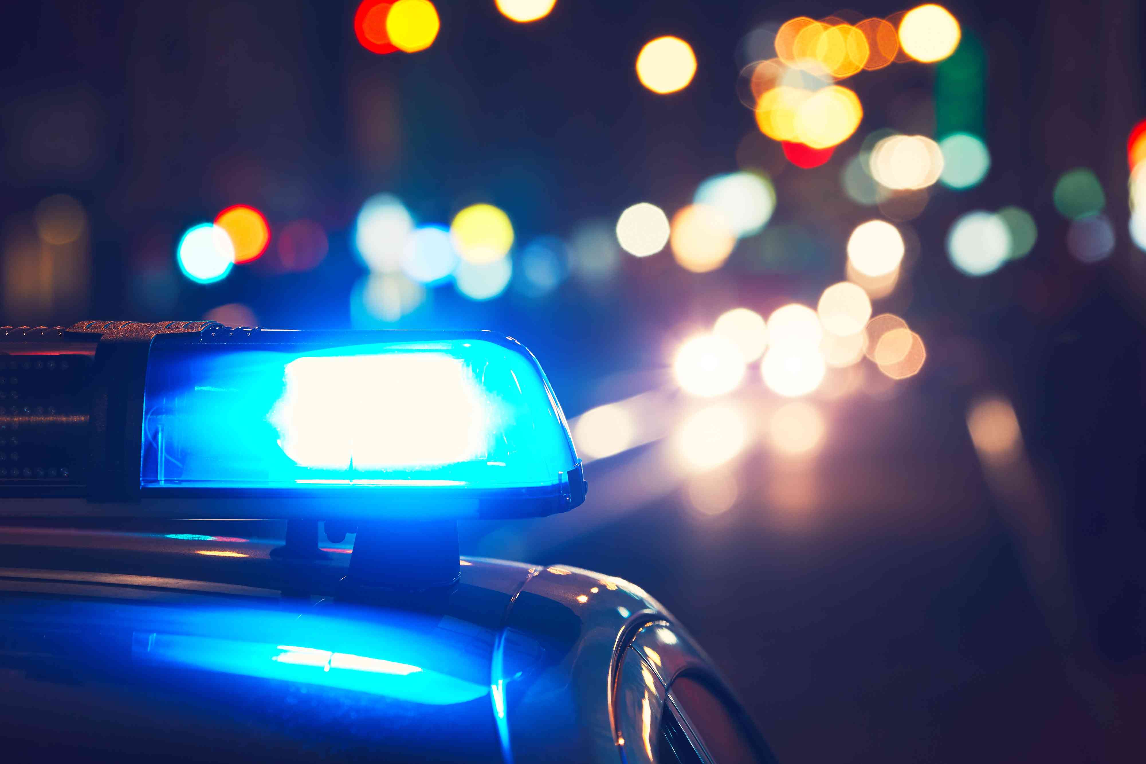 Close-Up Of Blue Siren On Police Car At Night