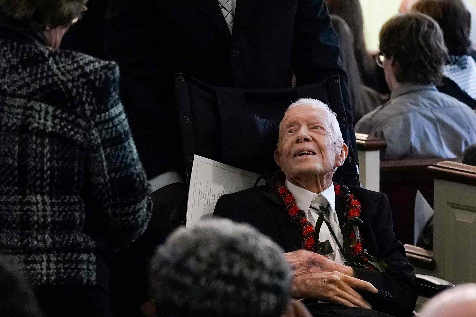 Former US President Jimmy Carter departs following a funeral service for former US First Lady Rosalynn Carter, at Maranatha Baptist Church in Plains, Georgia, on November 29, 2023.