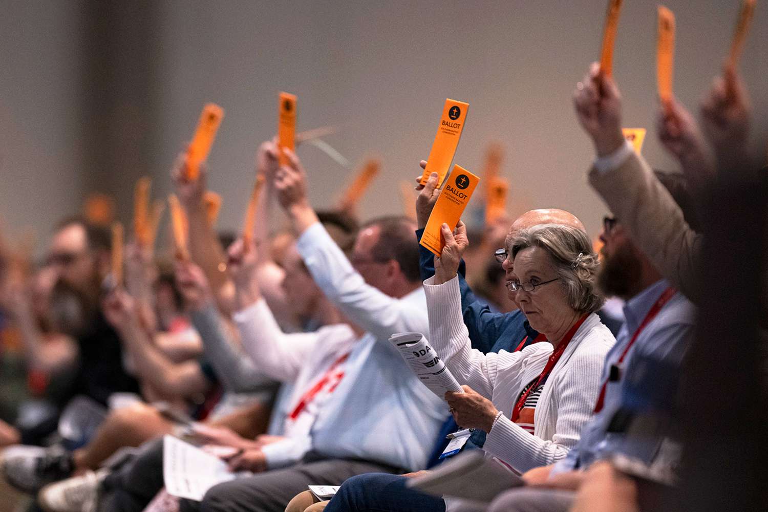 Messengers raise their ballots in support of a motion put up for vote during a Southern Baptist Convention annual meeting Tuesday, June 11, 2024, in Indianapolis.