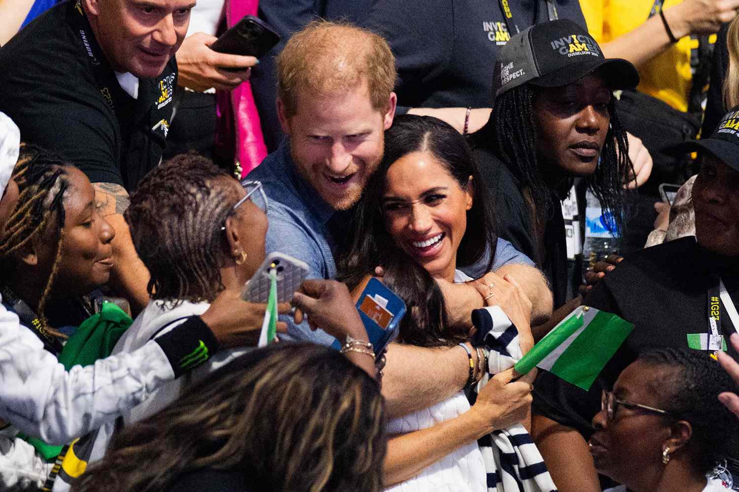 Prince Harry, Duke of Sussex, and his wife Meghan, Duchess of Sussex, watch sitting volleyball between fans from Nigeria and Ukraine at the 6th Invictus Games at the Merkur Spiel Arena