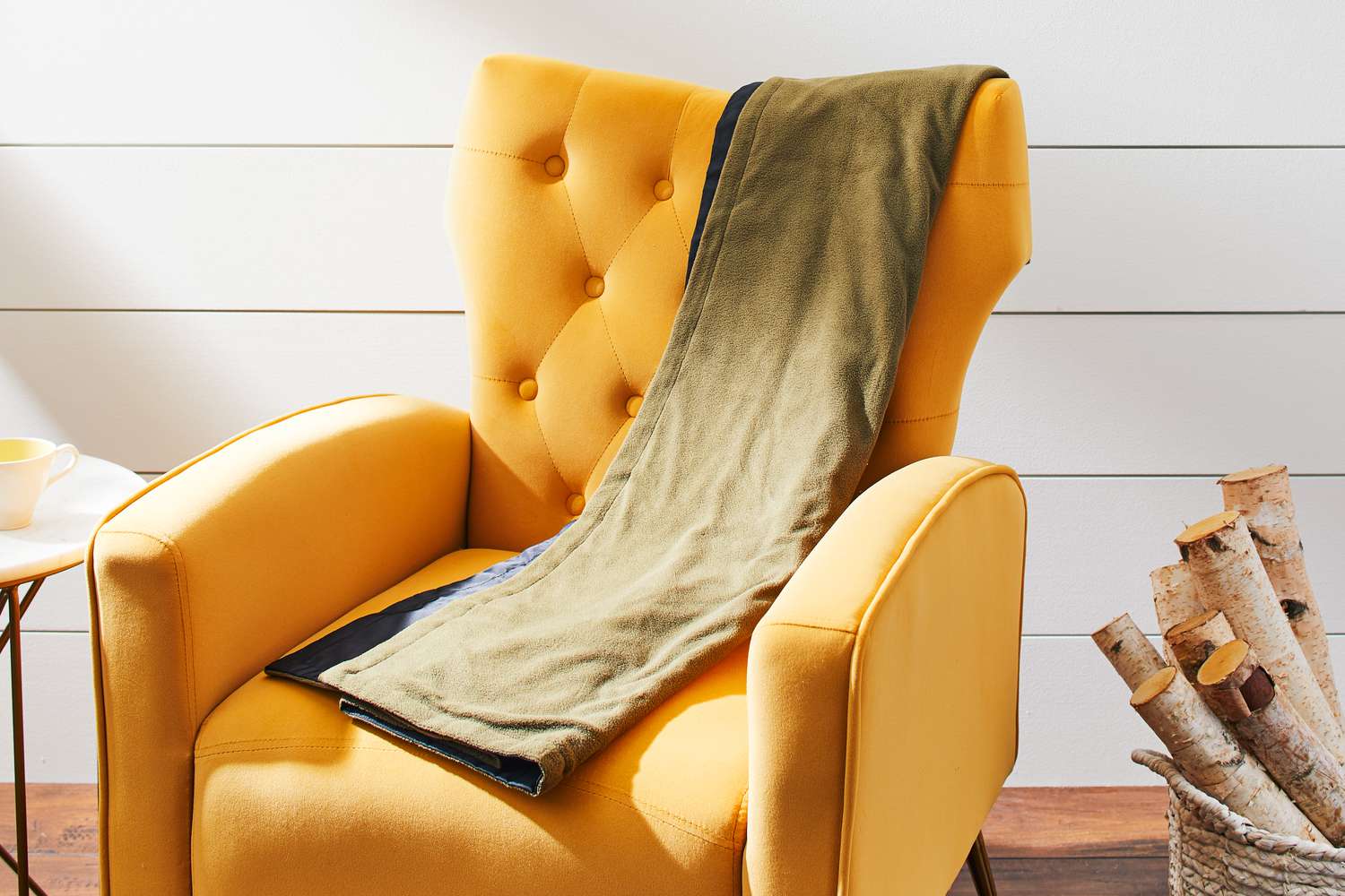 Eddie Bauer Portable Heated Throw Blanket draped over a chair