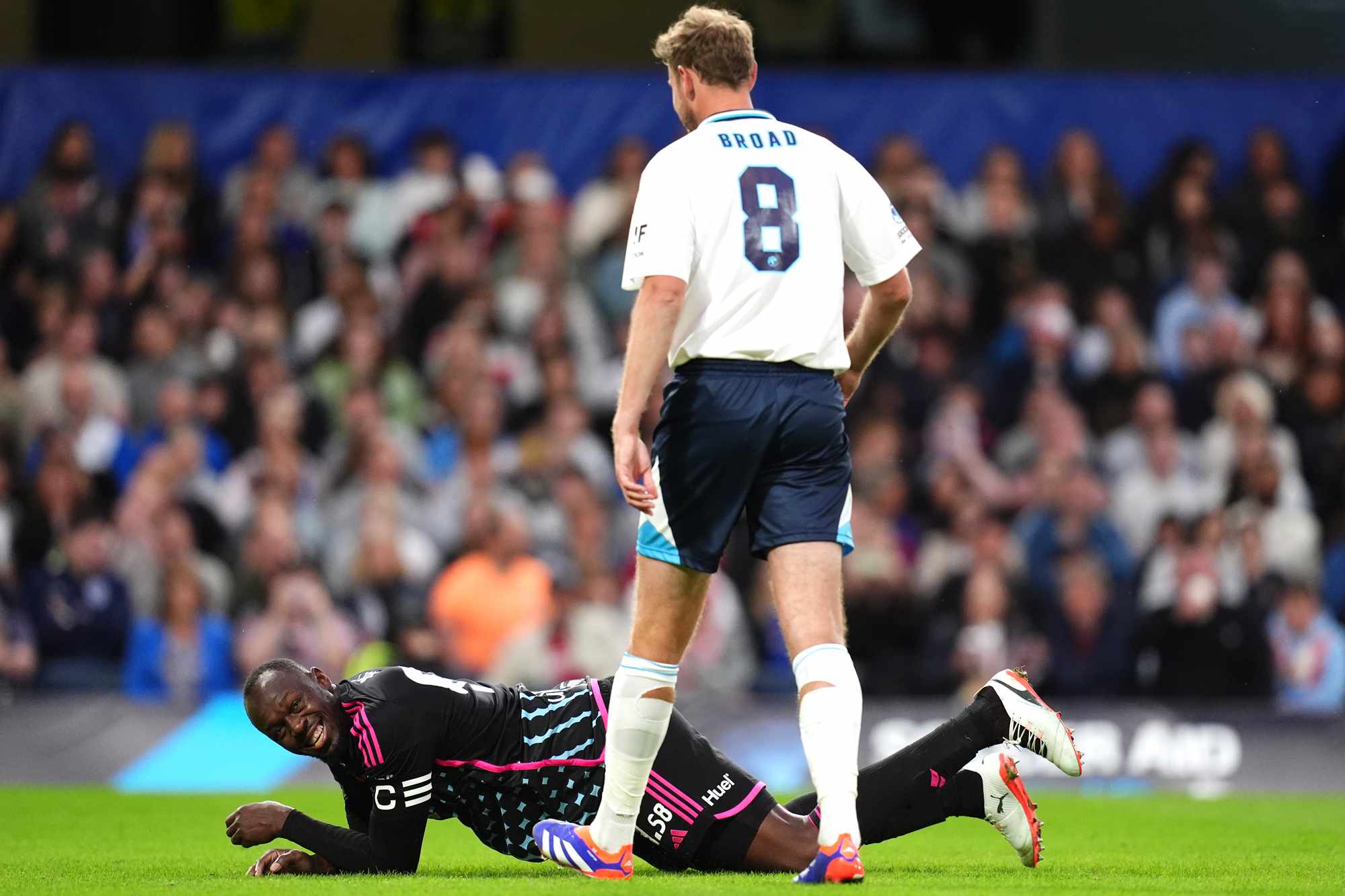 England's Stuart Broad (right) and World XI's Usain Bolt both react to a challenge during Soccer Aid for UNICEF 2024 at Stamford Bridge, London. Picture date: Sunday June 9, 2024. 