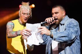 Travis Kelce sings with Machine Gun Kelly on stage during Kelce Jam at Azura Amphitheater on April 28, 2023 in Bonner Springs, Kansas. 