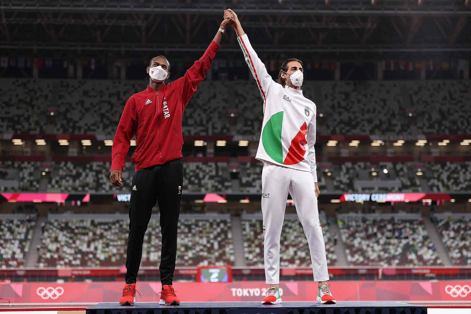 Joint gold medalists Mutaz Essa Barshim of Team Qatar and Gianmarco Tamberi of Team Italy celebrate on the podium during the medal ceremony for the Men's High Jump on day ten of the Tokyo 2020 Olympic Games at Olympic Stadium on August 02, 2021 in Tokyo, Japan. 