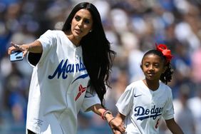 Vanessa Bryant walks her daughter Bianca Bryant, the daughter of former Los Angeles Laker Kobe Bryant, walk out to throw the first pitch before a MLB baseball game between the Tampa Bay Rays 