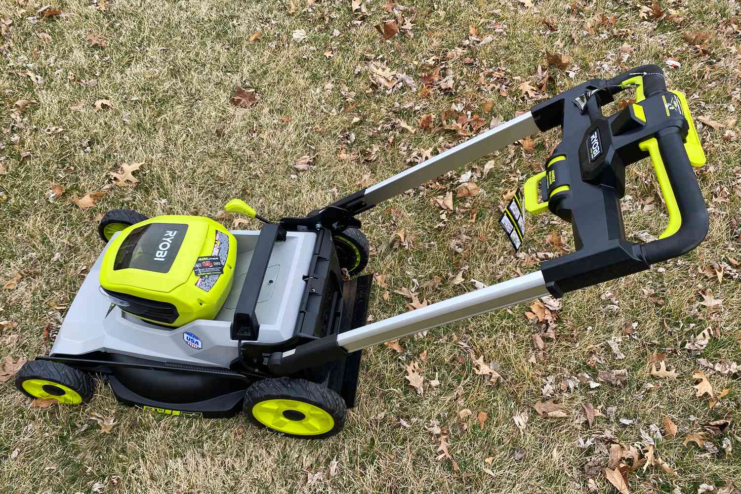 Ryobi 40V HP Brushless 21-Inch Dual-Blade Self-Propelled Mower displayed on a lawn with dry leaves