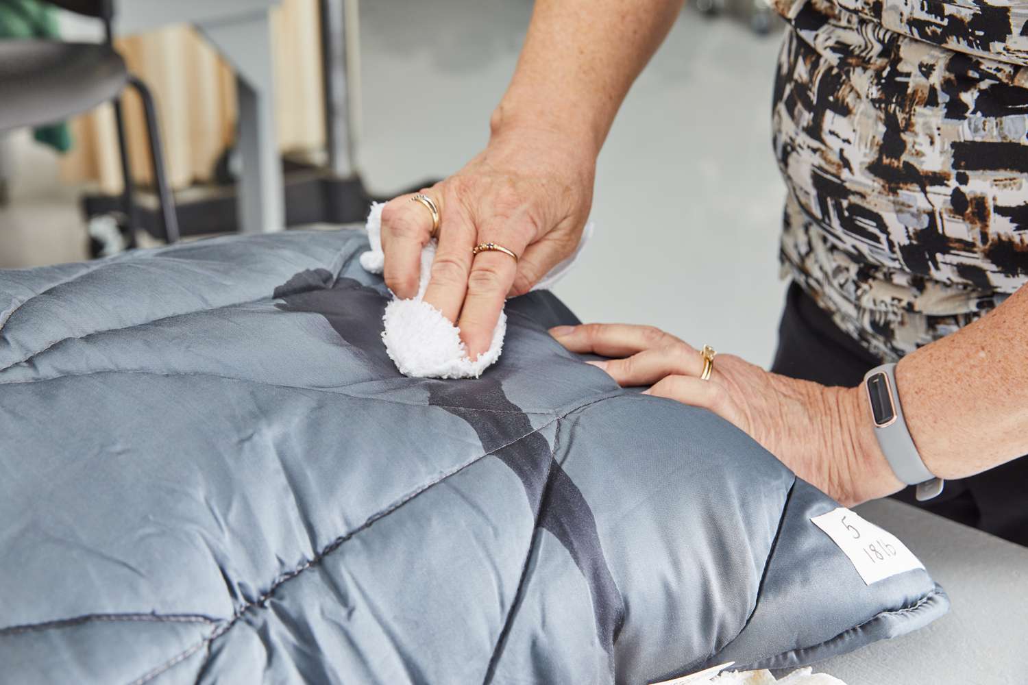 Nest Bedding Weighted Blanket being wiped