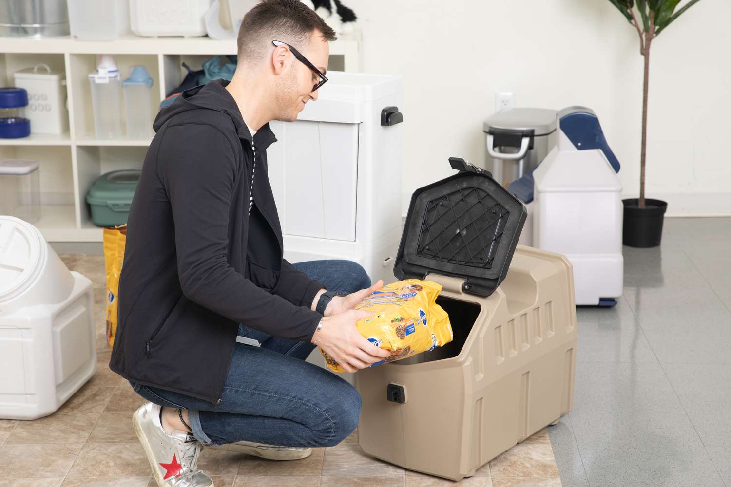 person filling Gunner Food Crate with dog food